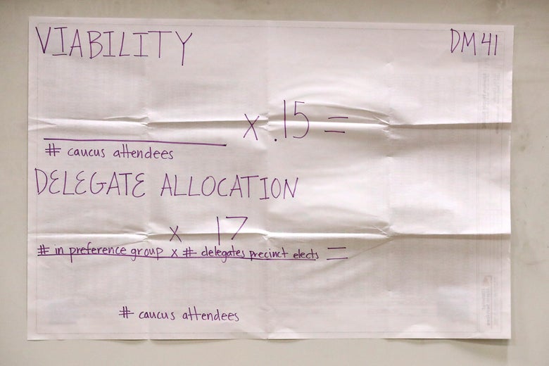 A poster explains the allocation of delegate count at a caucus at Roosevelt High School February 03, 2020 in Des Moines, Iowa.