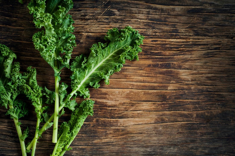 Some kale leaves on a table.
