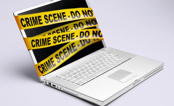 Computer with police tape.
