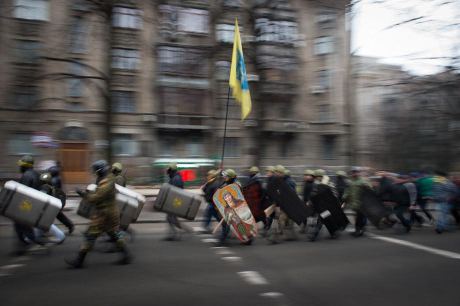 Protesters march in the streets of Kiev carrying flags and decorated shields on Feb. 15, 2014. 