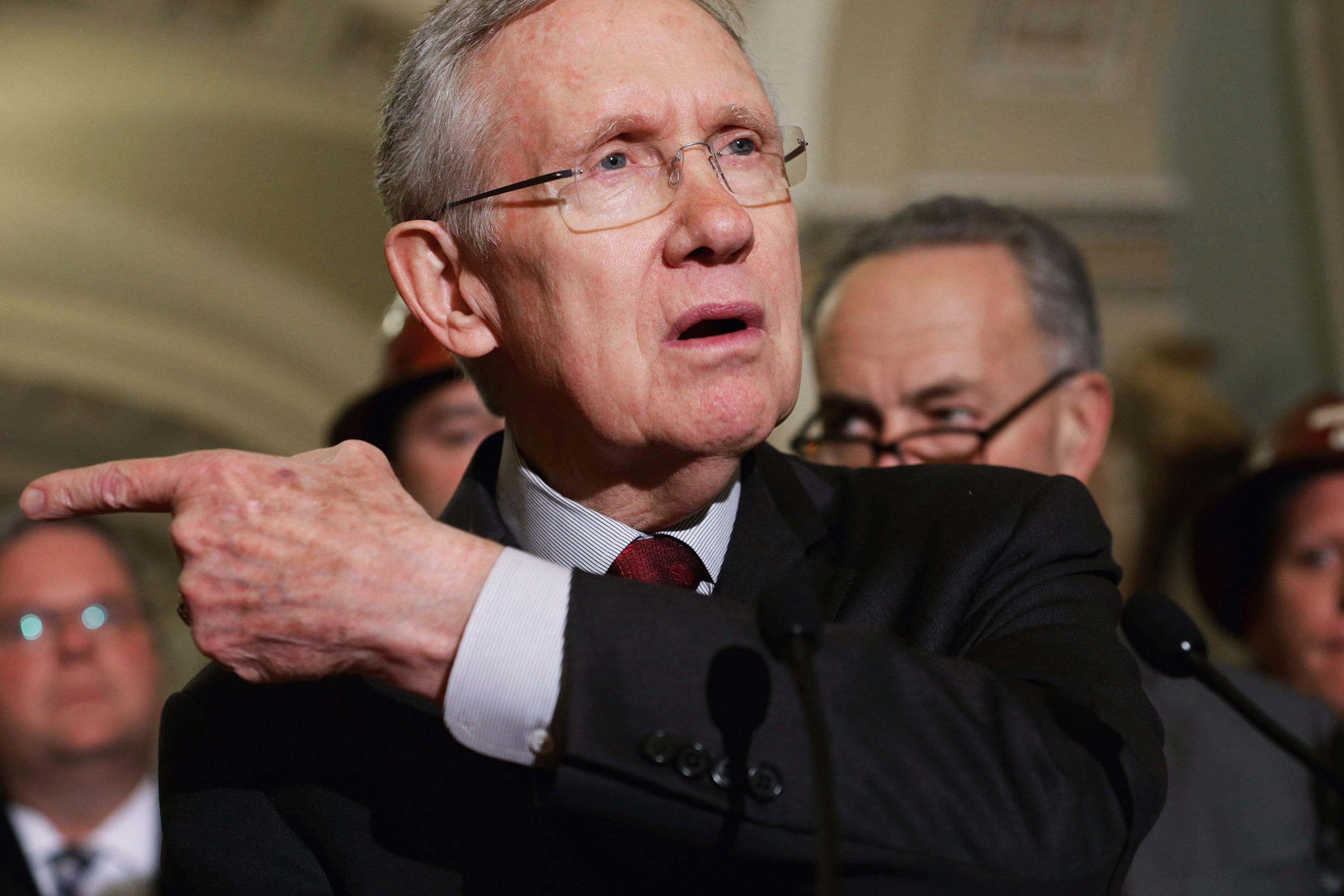 Harry Reid points with one hand.