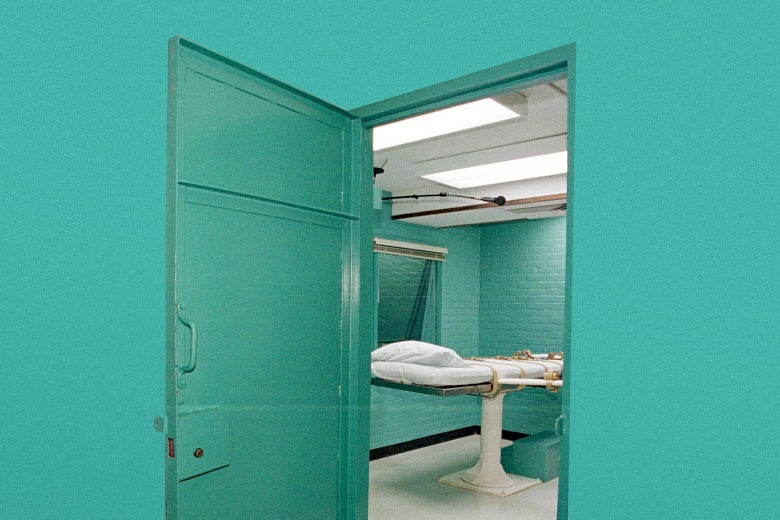 Open door revealing an empty execution chamber, with a cot. 