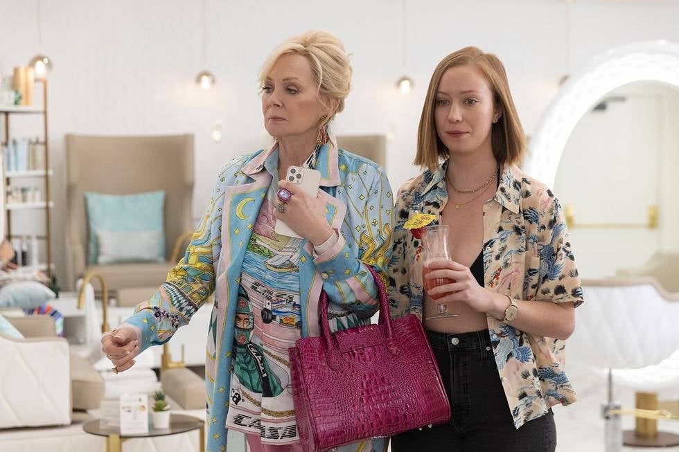 Two women, an older blonde and a younger redhead, in a department store.