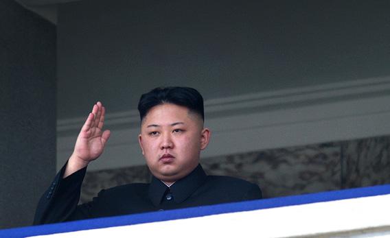 North Korean dear leader Kim Jong-Un salutes as he watches a military parade.