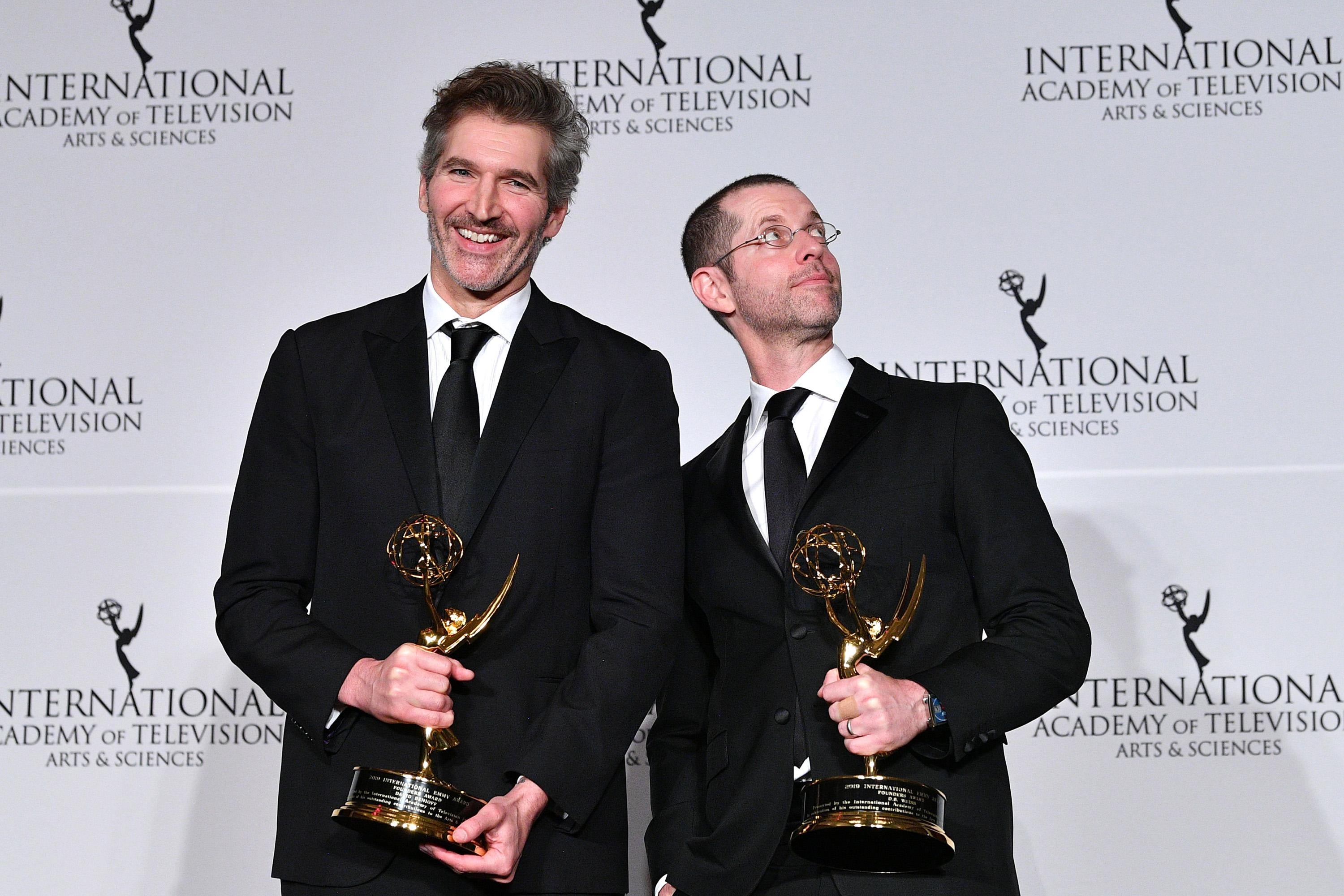 David Benioff and D.B. Weiss hold Emmy awards.