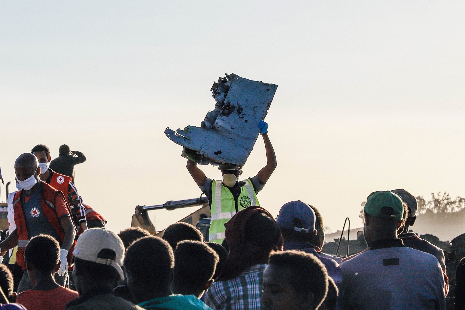 A man carries a piece of debris on his head at the crash site of a Nairobi-bound Ethiopian Airlines flight.