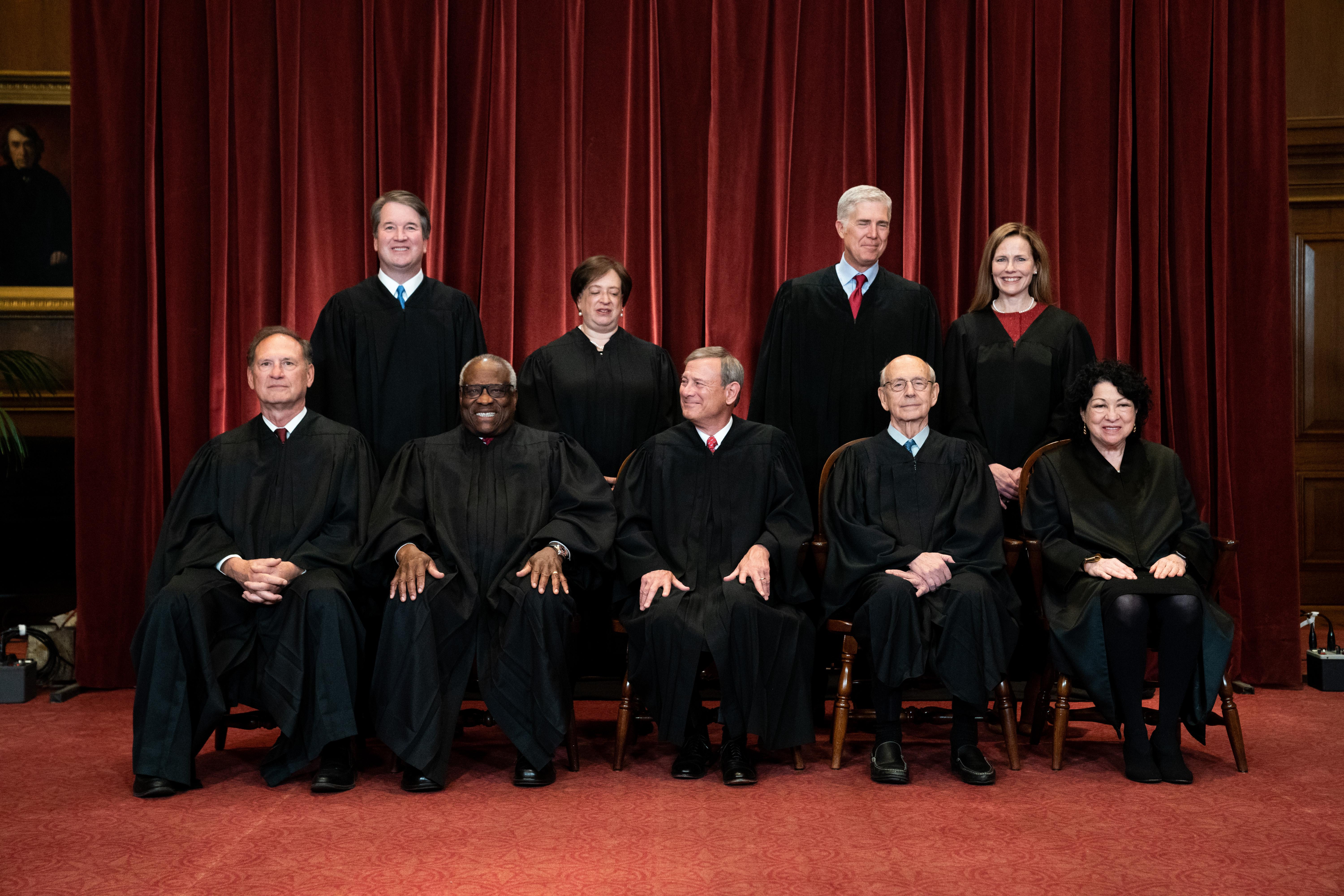 The Supreme Court justices pose for their group photo.