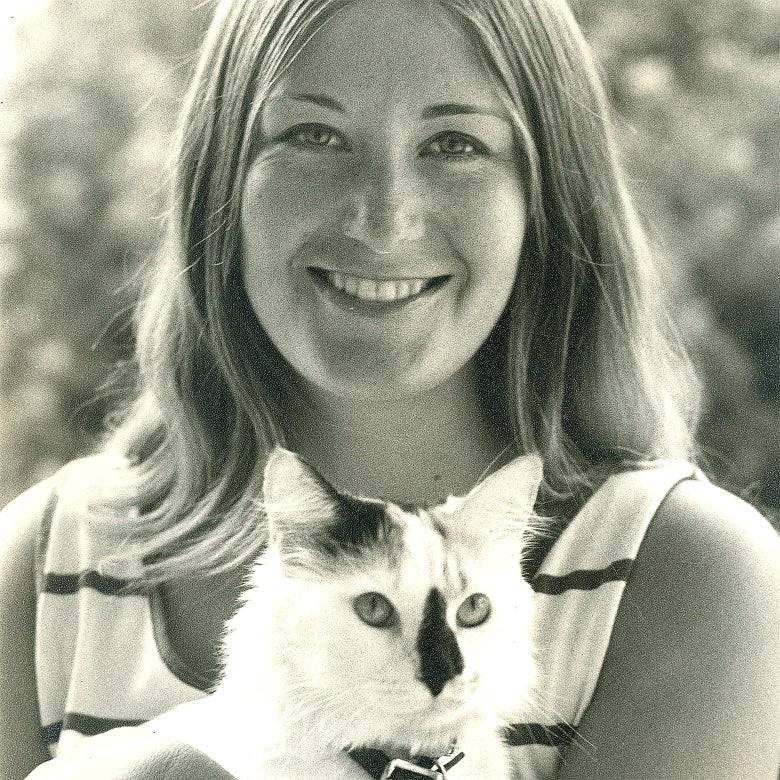 A close-up of Shirley Wheeler embracing her cat.