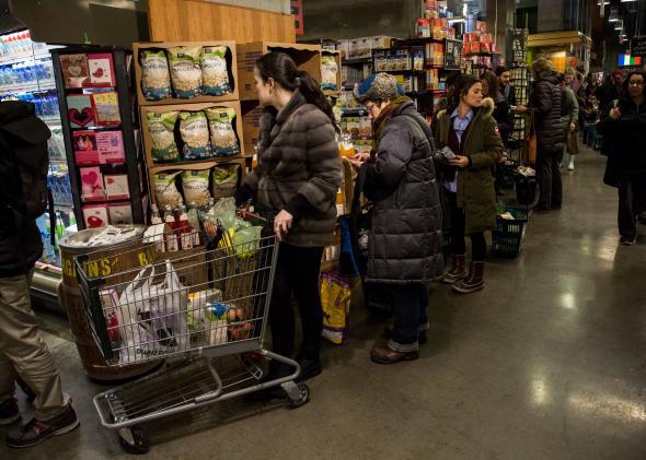 New Yorkers wait in a long line at Whole Foods as a major snowstorm begins on Jan. 26, 2015 in New York City. 