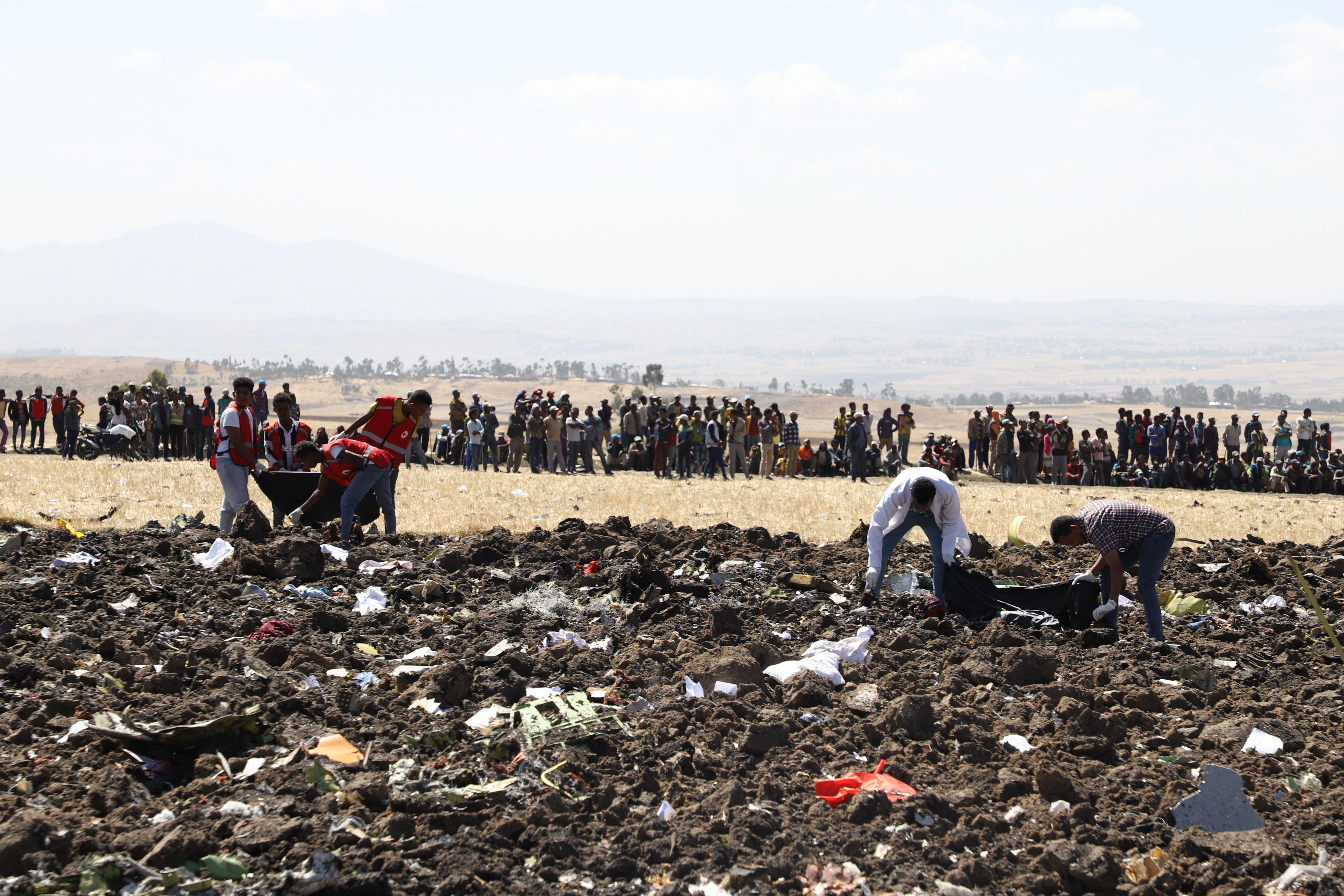 Rescue team collect remains of bodies amid debris at the crash site of Ethiopia Airlines near Bishoftu, a town southeast of Addis Ababa, Ethiopia, on March 10, 2019. 