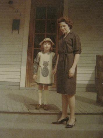 1966. She made my dress and cat pinafore, and she probably made her dress too. 