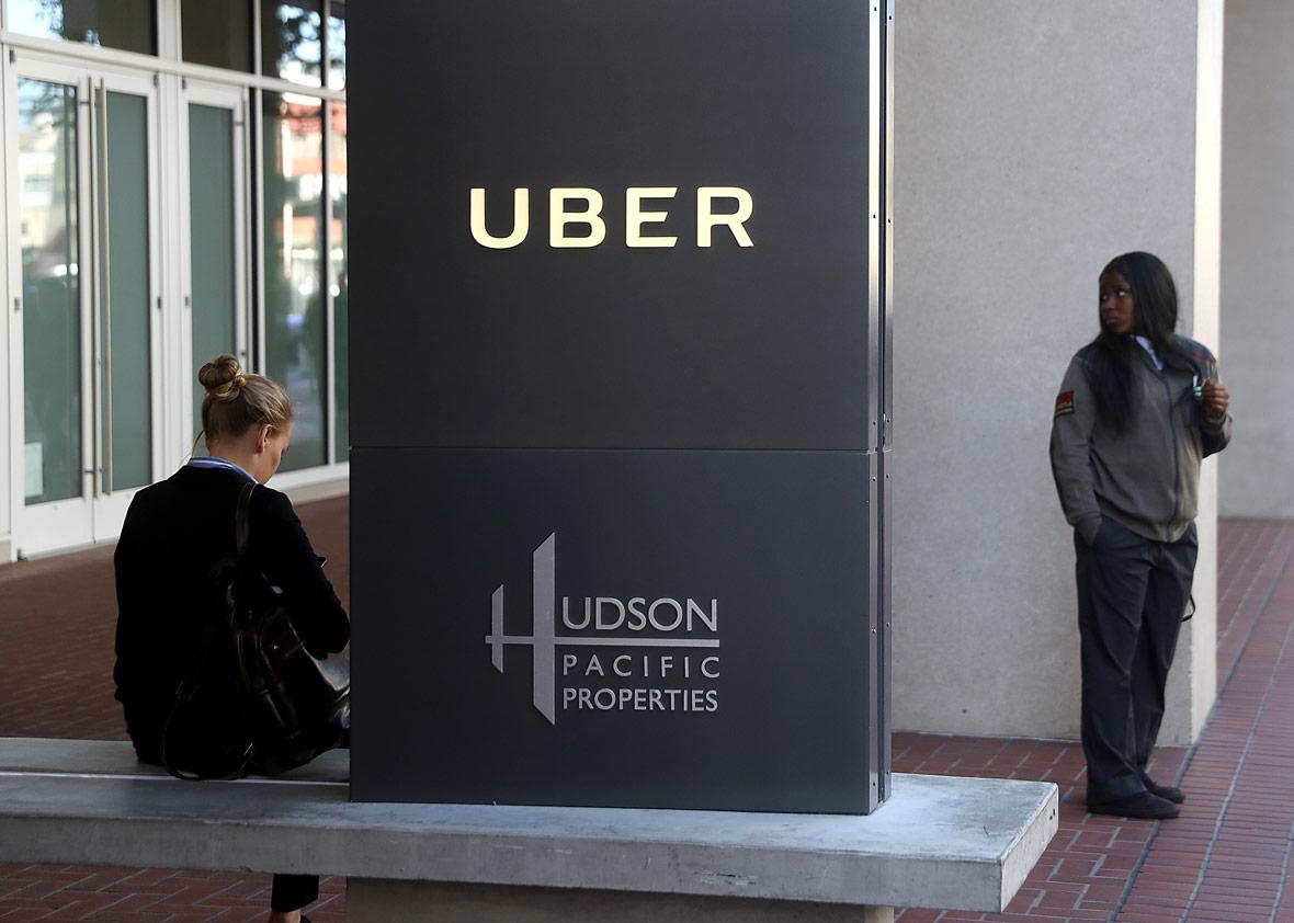A private security guard stands in front of Uber headquarters 