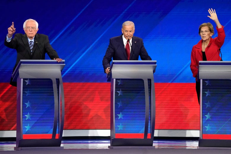 Bernie Sanders, Joe Biden, and Elizabeth Warren onstage, raising their hands.