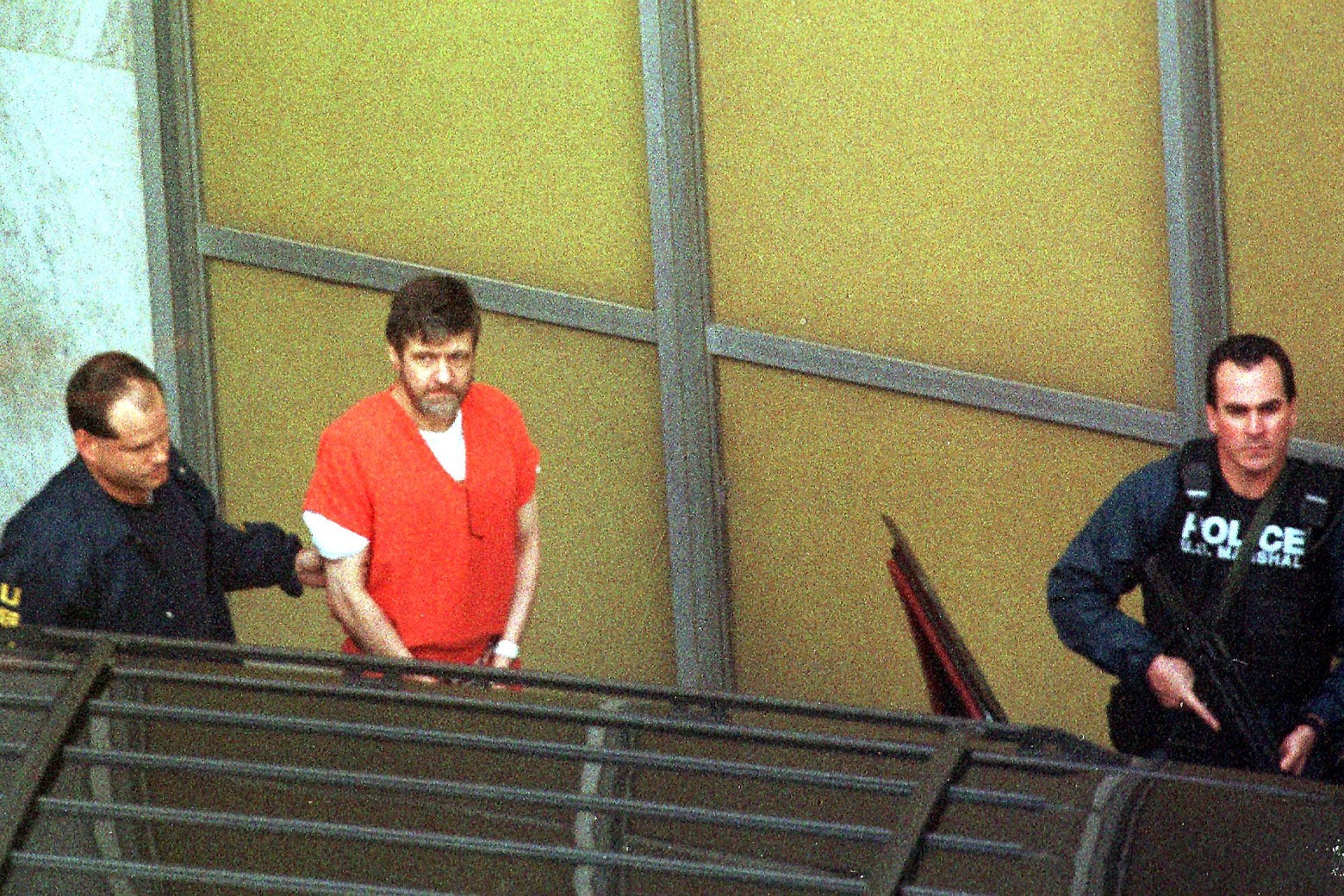 Theodore Kaczynski is led out by U.S. Marshals in Sacramento, California, after admitting to being the Unabomber.