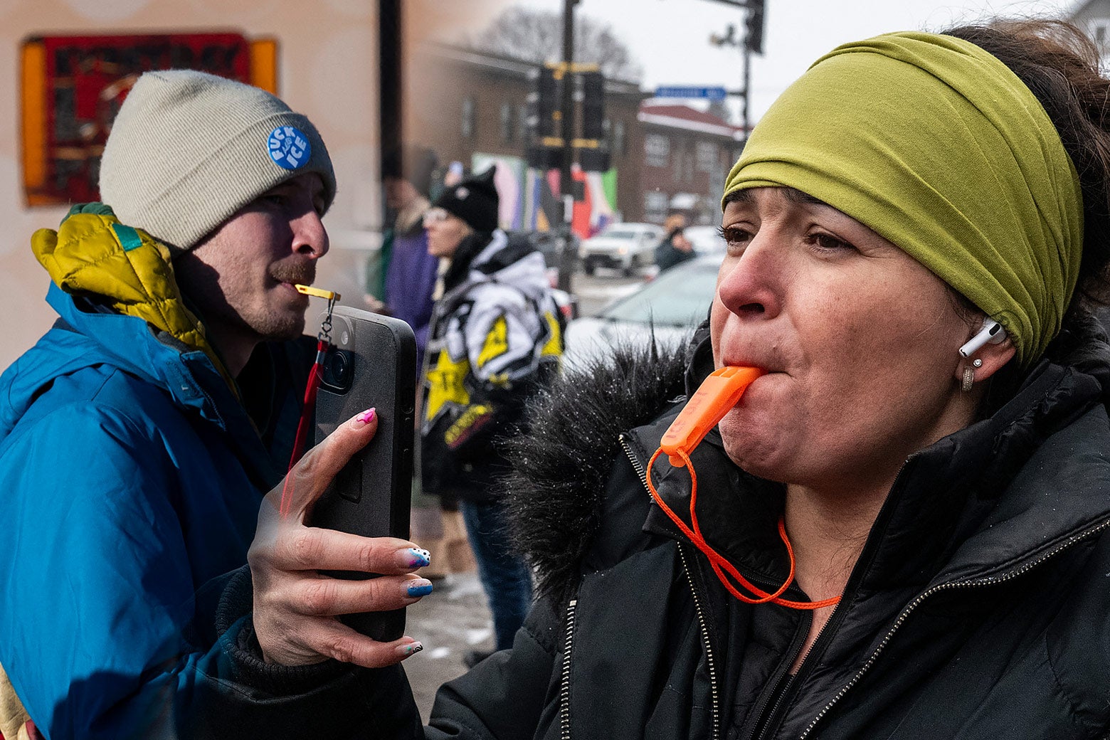 People on the street protesting ICE actions by blowing flat, colorful, 3D-printed whistles.