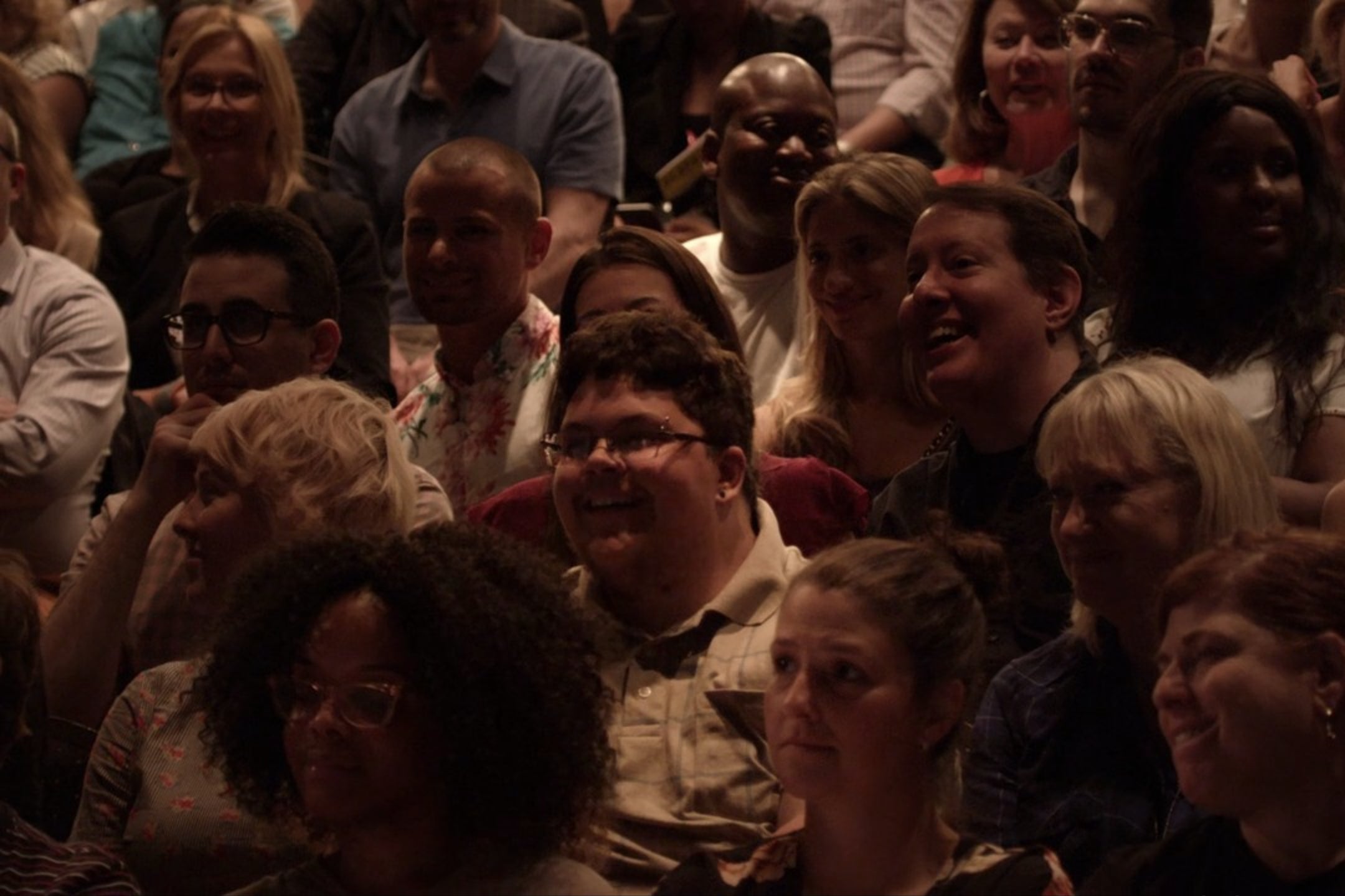 A theatrical audience. Tituss Burgess is a few rows behind Gavin Grimm.