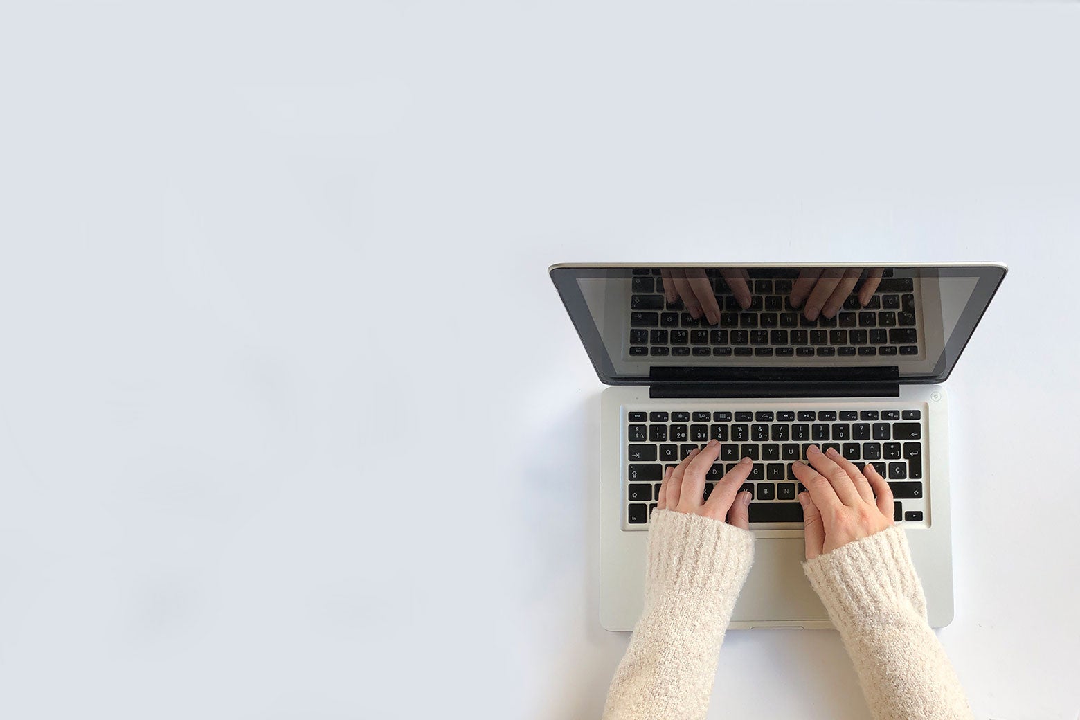 A writer typing on a laptop.