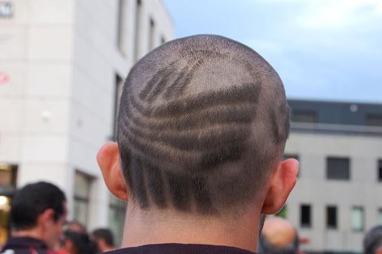 An Andorran athlete with the LieGames logo shaved in his hair. 