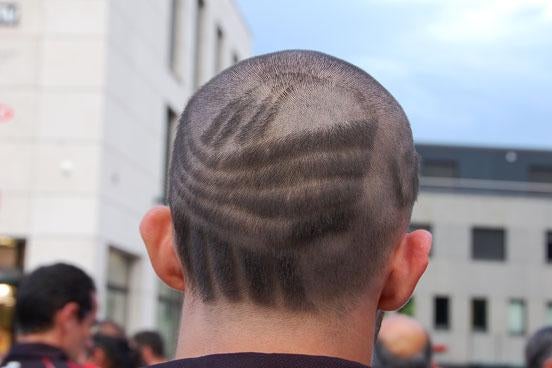 An Andorran athlete with the LieGames logo shaved in his hair.