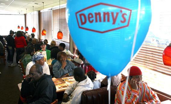 Customers fill the seats of a Denny's restaurant to receive a free Grand Slam breakfast.,56634833