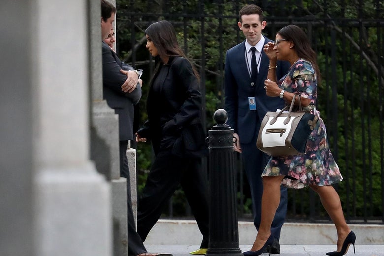 Kim Kardashian and entourage walk into White House grounds .