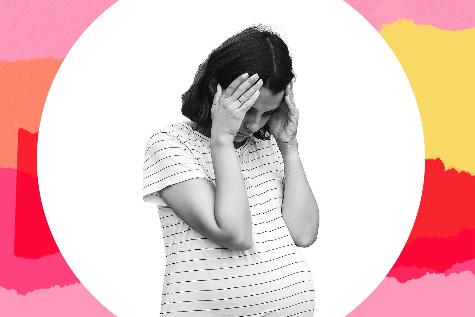 A pregnant woman holds her head in her hands in worry.