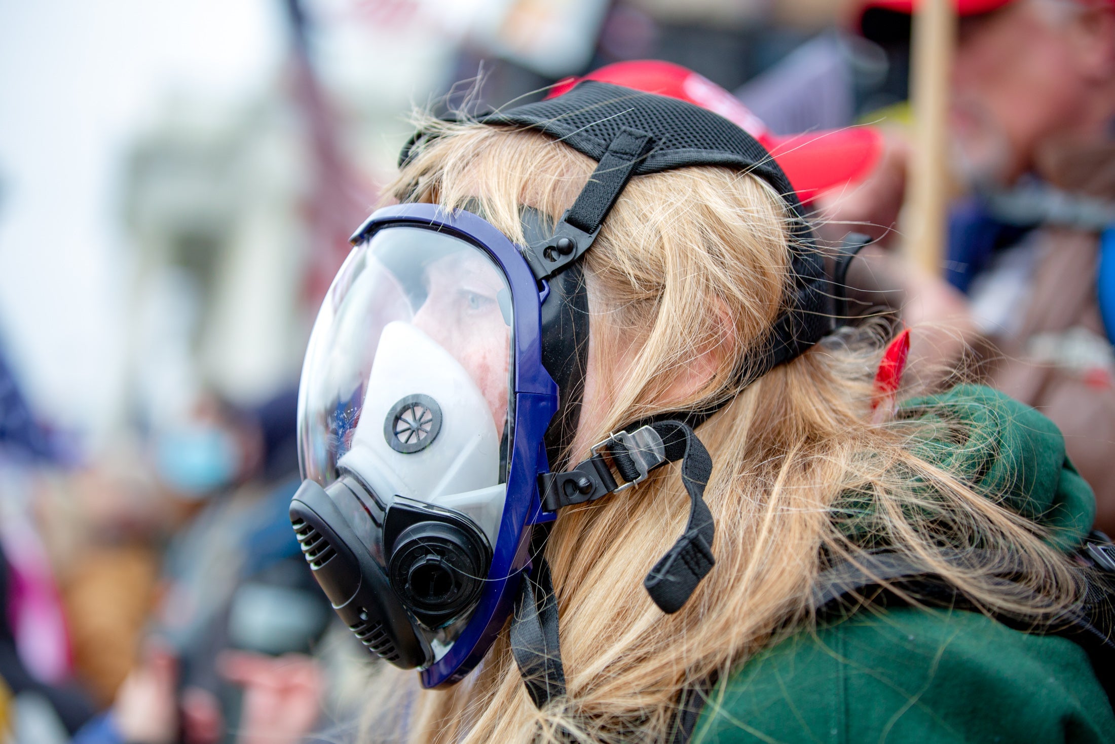 A woman in a gas mask at the Save America March in D.C.