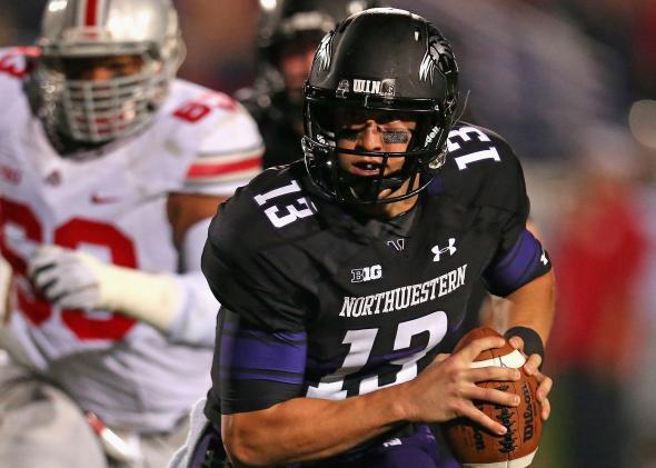 Northwestern University quarterback Trevor Siemian runs as he looks for a receiver against the Ohio State Buckeyes at Ryan Field on Oct. 5, 2013, in Evanston, Illinois.