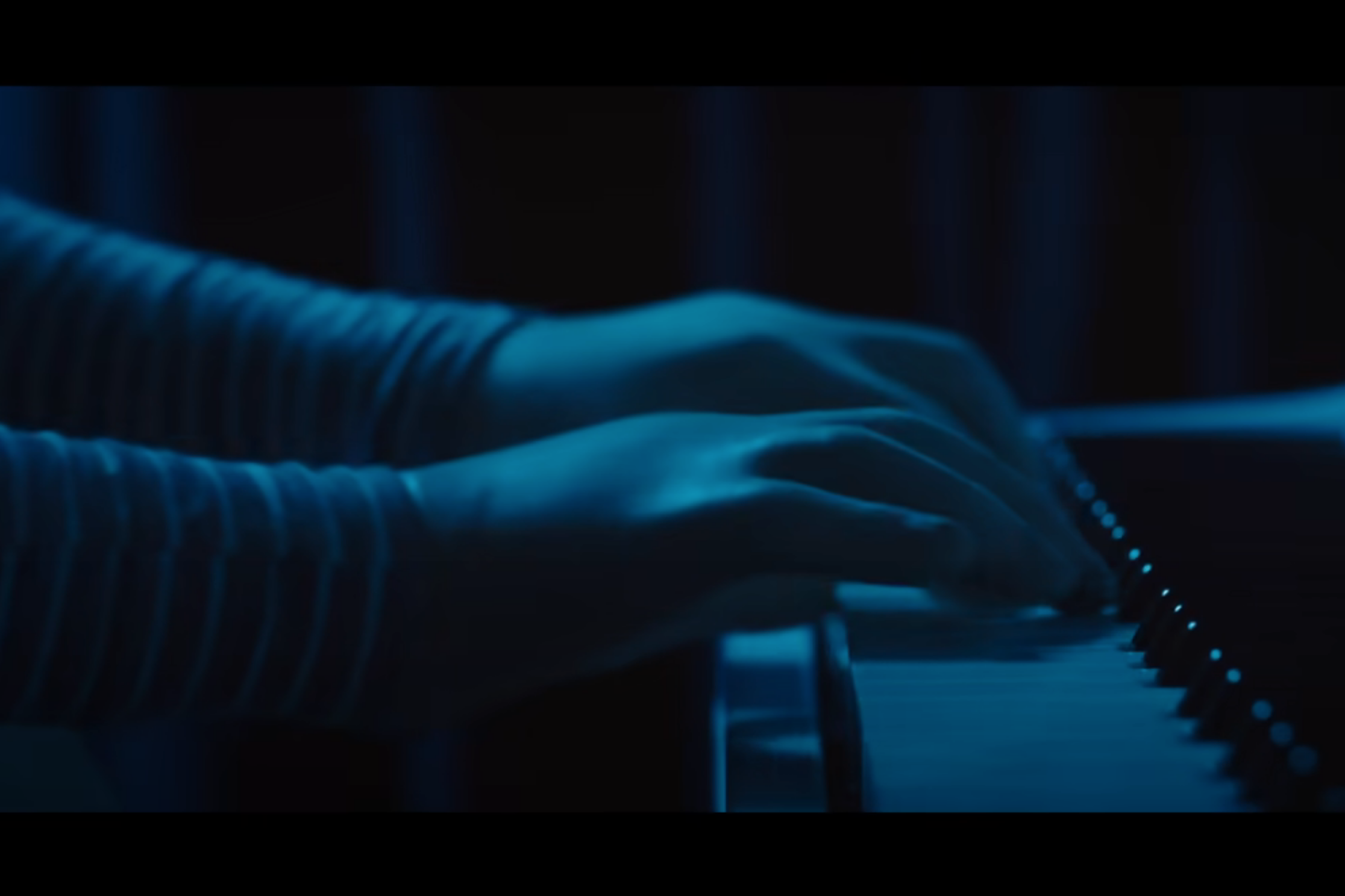 M3gan's hands on the piano.