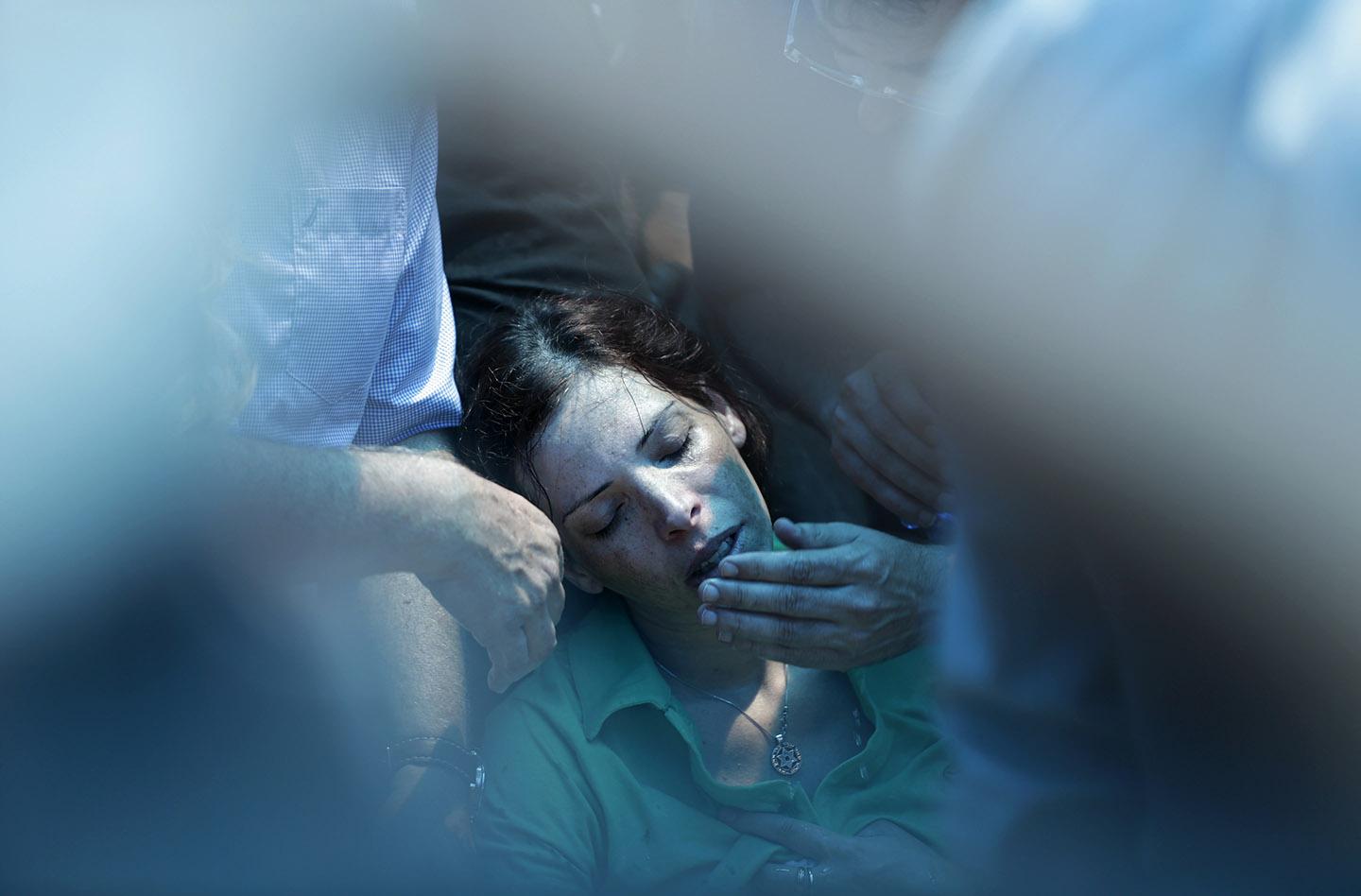 Dana, the sister of Israeli soldier Tsafrir Bar-Or, mourns during his funeral.