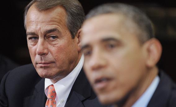 Speaker of the House John Boehner (R-OH), left, listens as U.S. President Obama speaks.