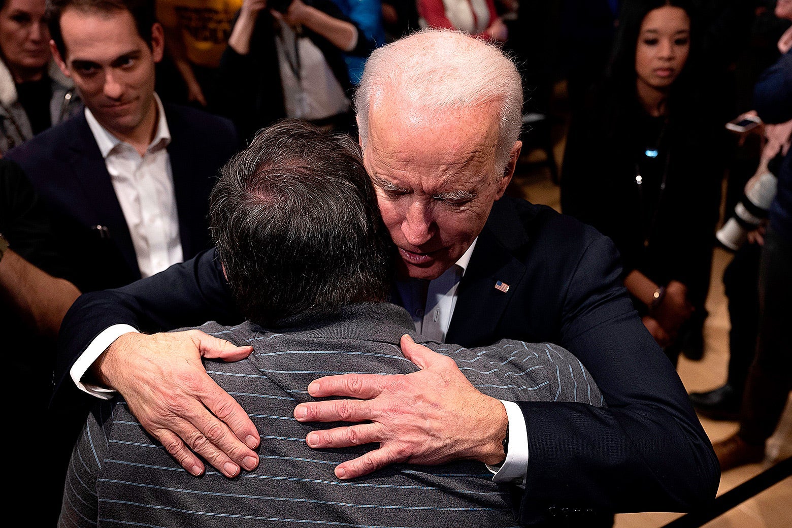 Joe Biden hugs a supporter during a town hall meeting in Newton, Iowa, on January 30, 2020.