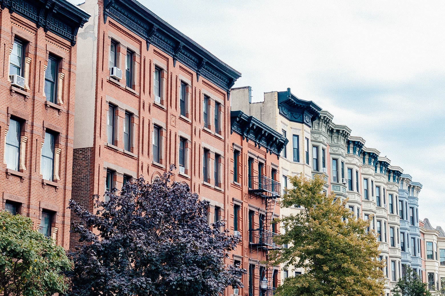 A row of colorful old brick residential buildings
