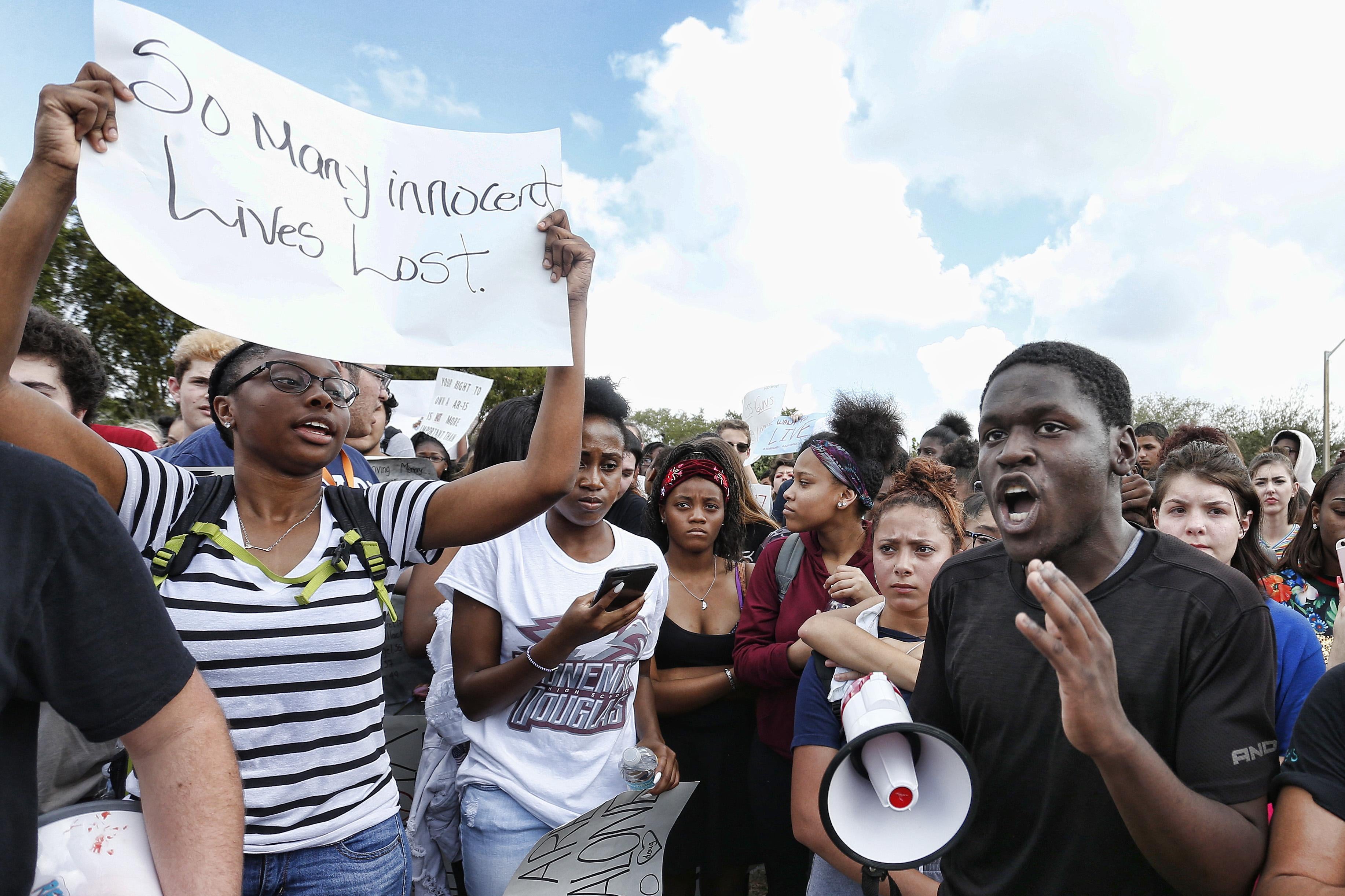 Students of area High Schools rally at Marjory Stoneman Douglas High School after participating in a county wide school walk out in Parkland, Florida on February 21, 2018. 
A former student, Nikolas Cruz, opened fire at Marjory Stoneman Douglas High School leaving 17 people dead and 15 injured on February 14. / AFP PHOTO / RHONA WISE        (Photo credit should read RHONA WISE/AFP/Getty Images)