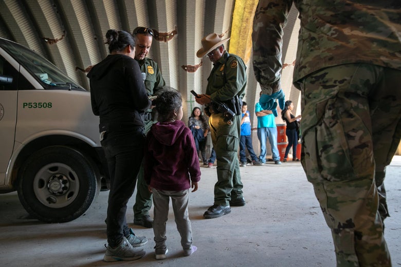 Families, mostly from Central America, wait to be transported to a U.S. Customs and Border Protection processing center after they crossed the Rio Grande from Mexico and presented themselves to border agents on September 10, 2019 in Los Ebanos, Texas.