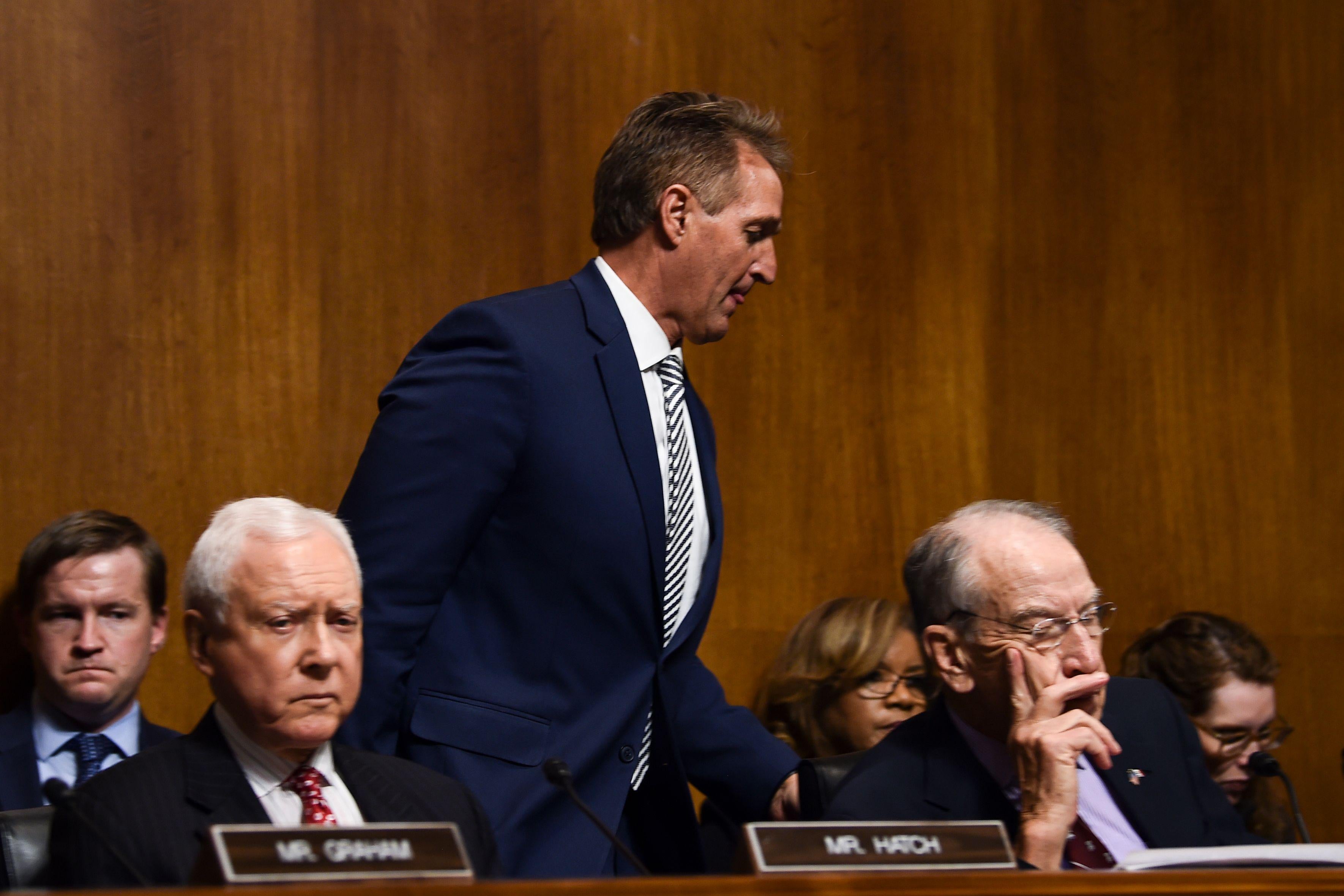 Jeff Flake walks out during a hearing on Brett Kavanaugh's nomination.