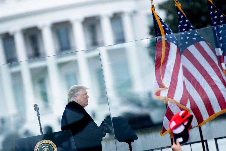 Trump walking away from the podium with the White House in the background.