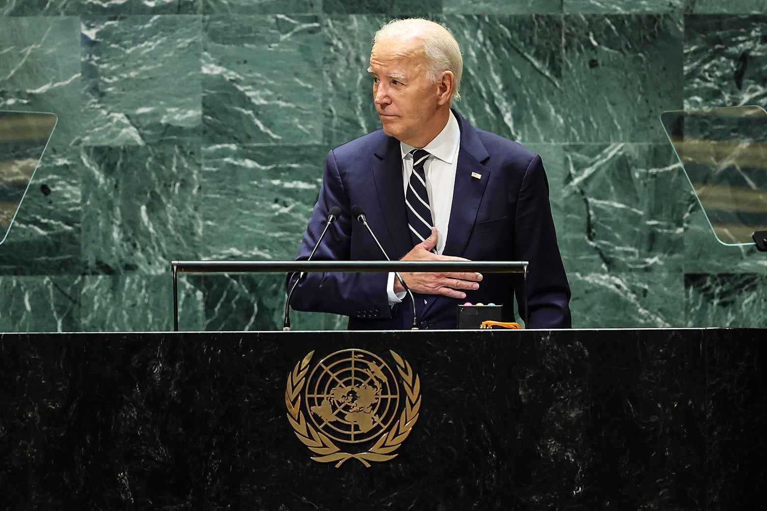 President Joe Biden speaks at the United Nations with his hand just below his heart.