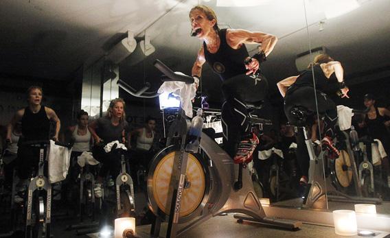 A fitness instructor leading a SoulCycle class.