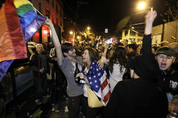 Revelers display U.S. and gay pride flags as they celebrate early election returns favoring Washington state Referendum 74.