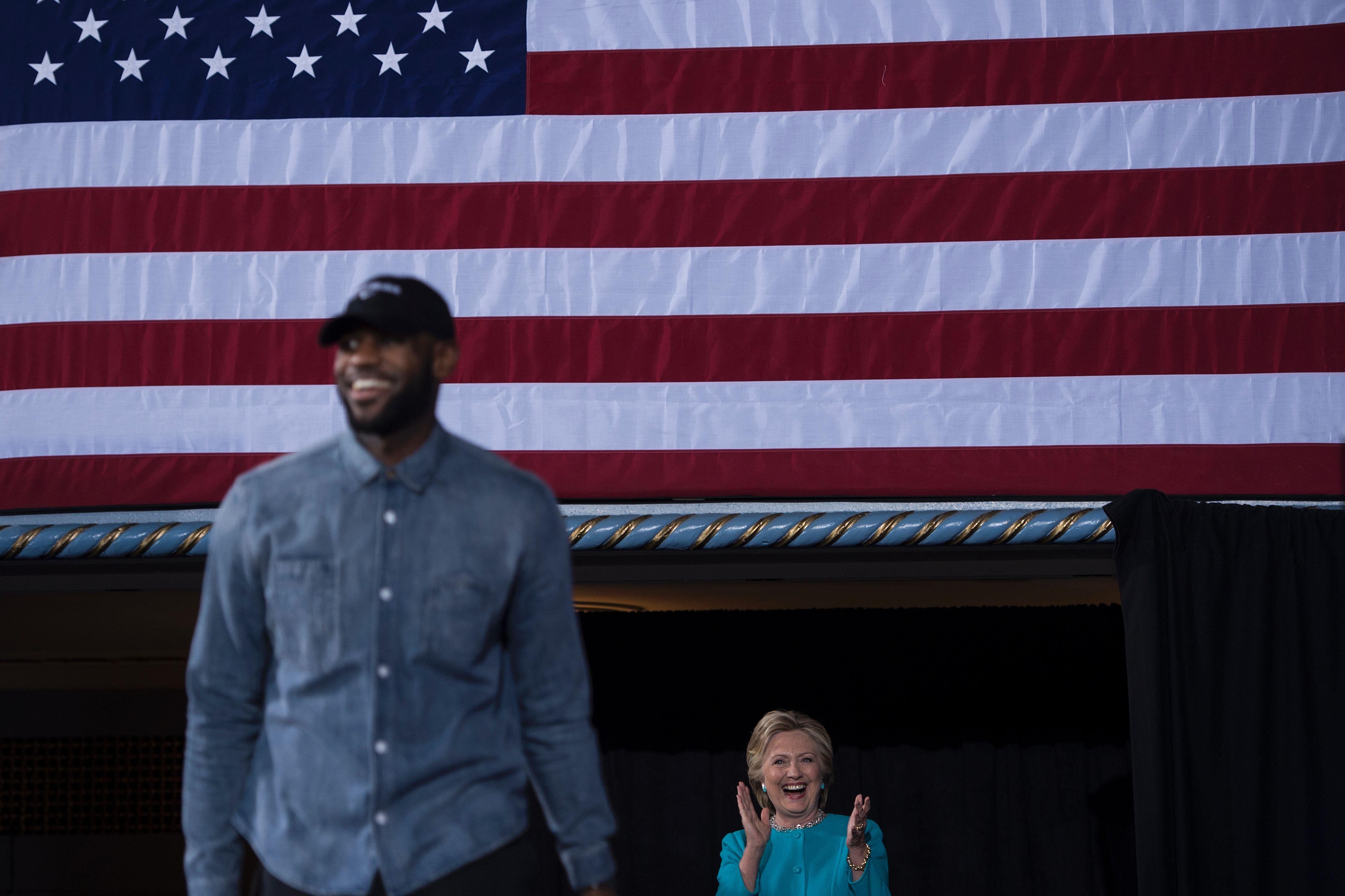 NBA basketball player Lebron James and Hillary Clinton arrive for a rally at the Cleveland Public Auditorium November 6, 2016 in Cleveland, Ohio.