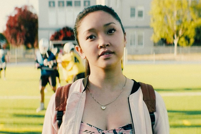 In a scene from To All the Boys I've Loved Before, Lara Jean (Lana Condor) stands on a lacrosse field, looking forward wistfully.