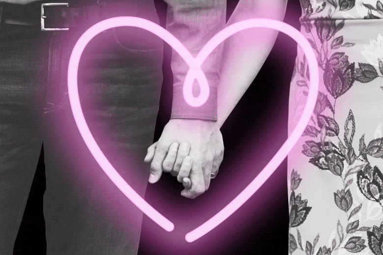Couple holding hands overlaid with an animation of a heart that then becomes many hearts.