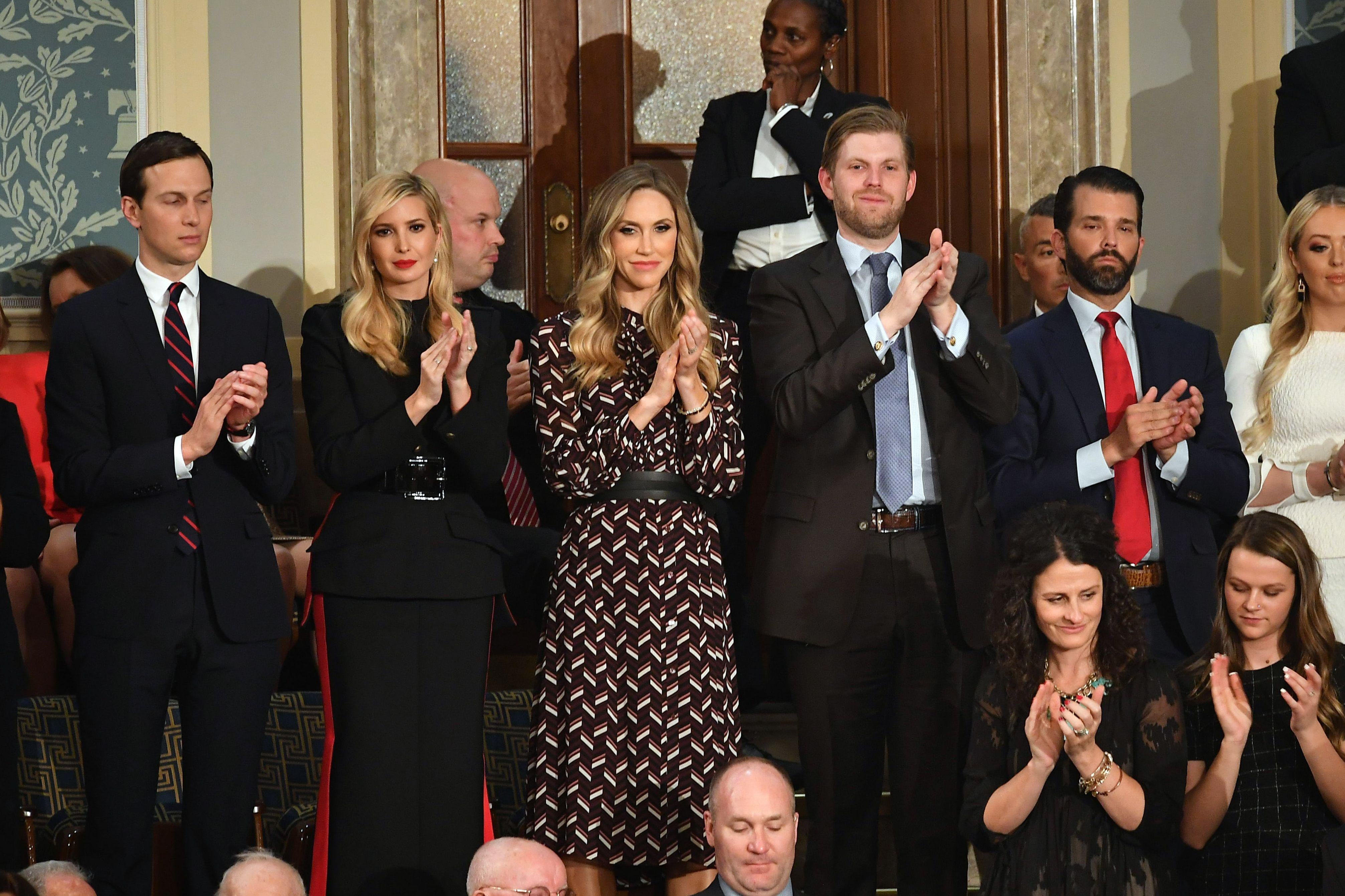  Jared Kushner, Ivanka Trump, Eric Trump, and Donald Trump, Jr., stand and applaud during a state of the union address.