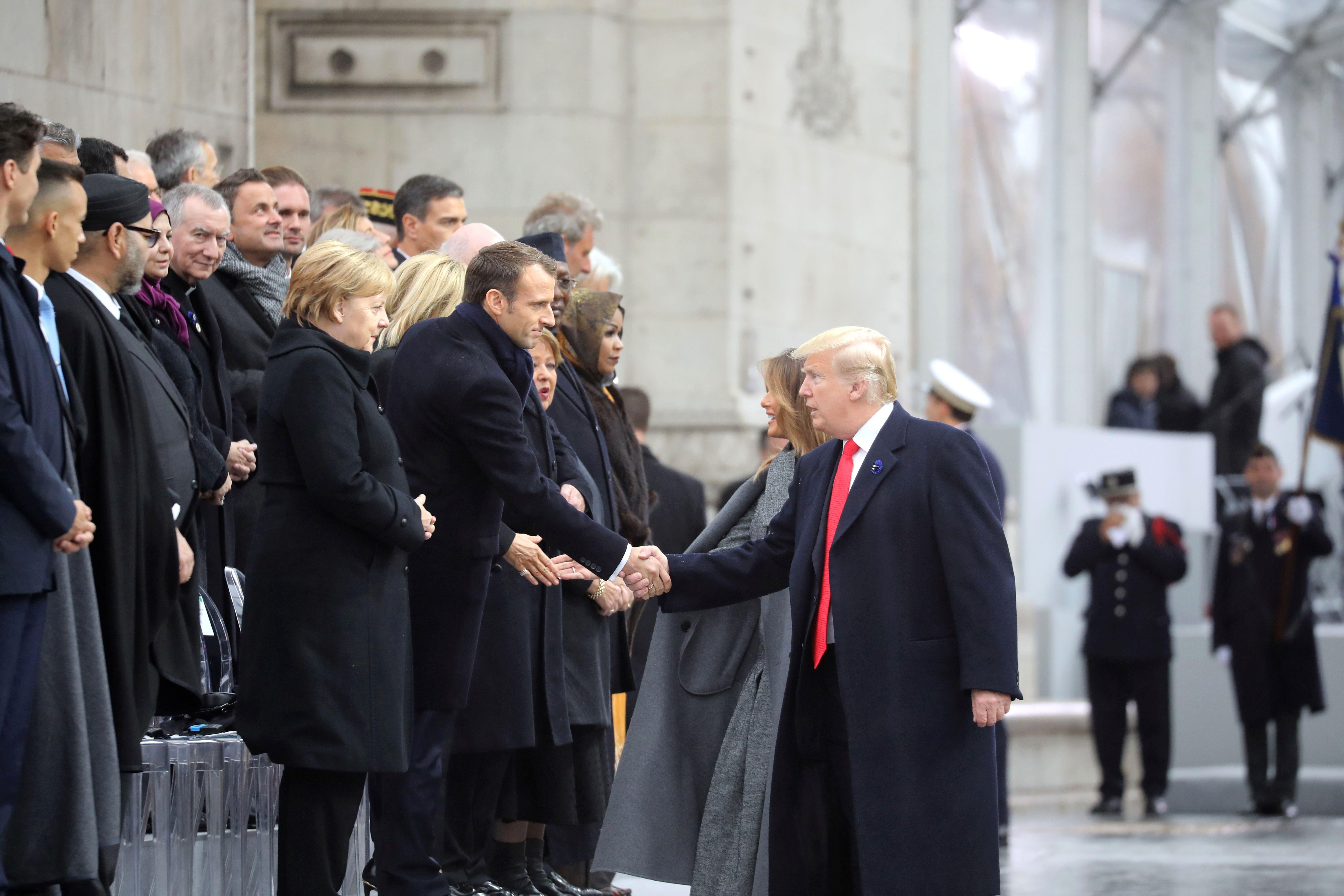US president Donald Trump shakes hands with French president Emmanuel Macron as he arrives at the Arc de Triomphe in Paris on November 11, 2018 to attend a ceremony as part of commemorations marking the 100th anniversary of the 1918 armistice.