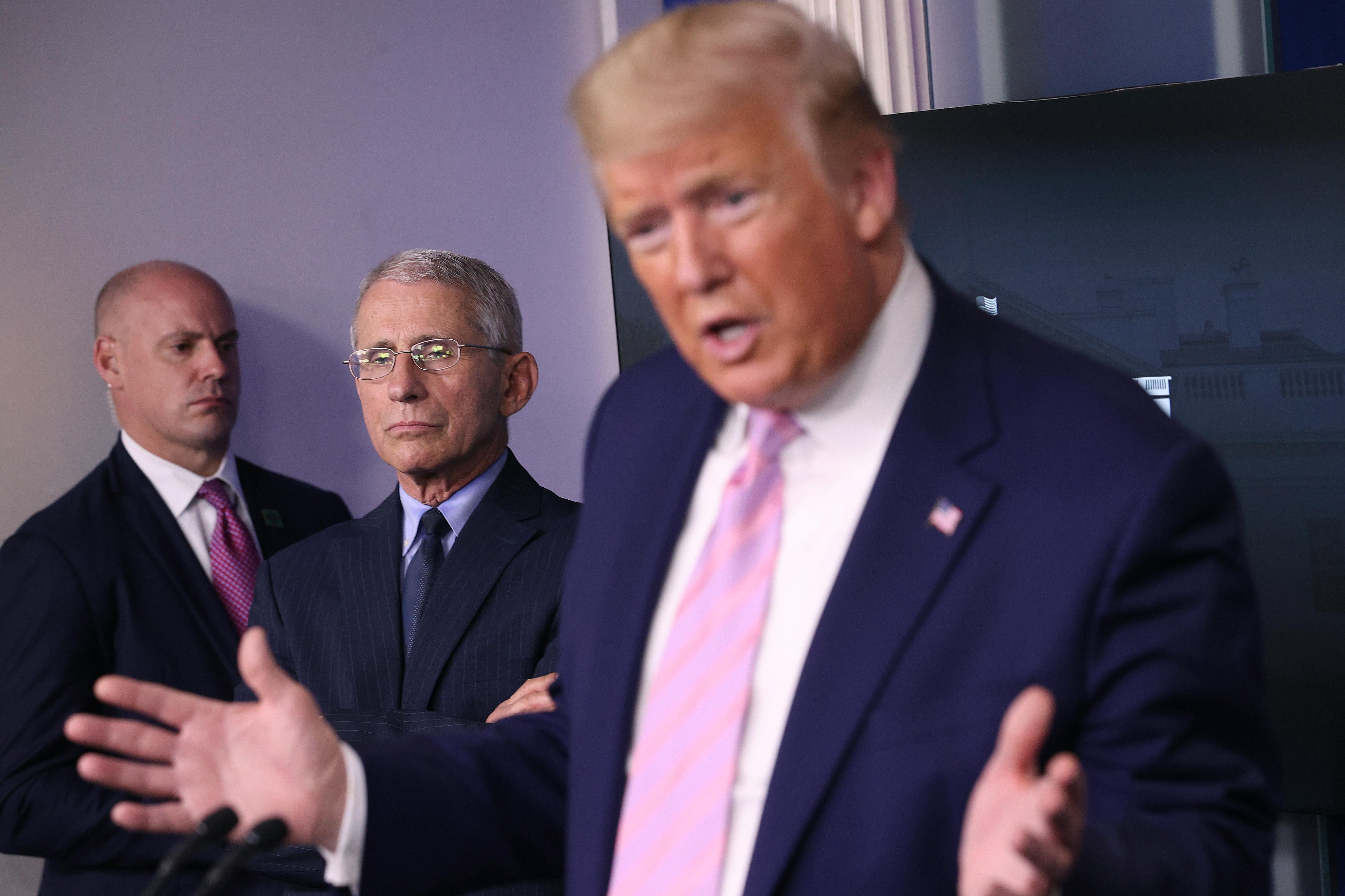 Anthony Fauci, director of the National Institute of Allergy and Infectious Diseases, listens to President Donald Trump speak from the press briefing room with members of the White House Coronavirus Task Force on April 1, 2020 in Washington, D.C.