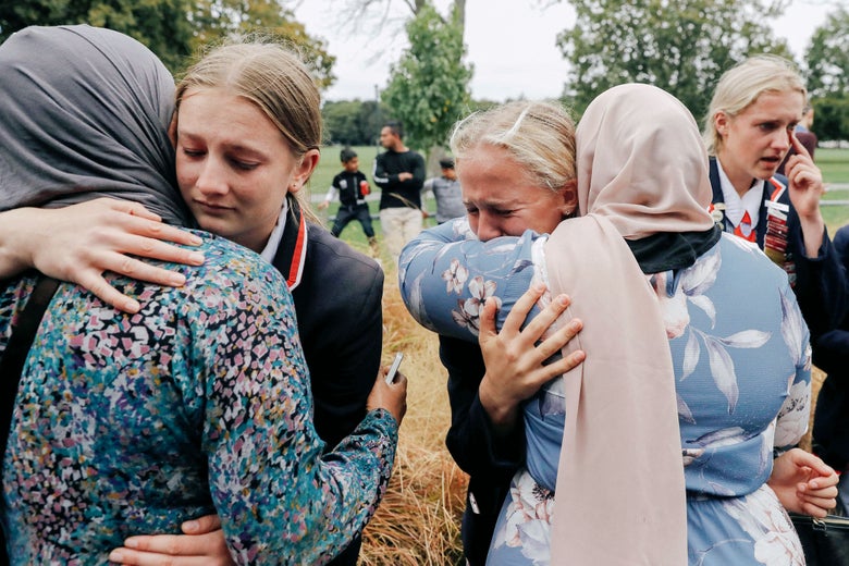 High school students from a Christian school embrace Muslims waiting for news of their relatives following Friday’s shooting in Christchurch, New Zealand.