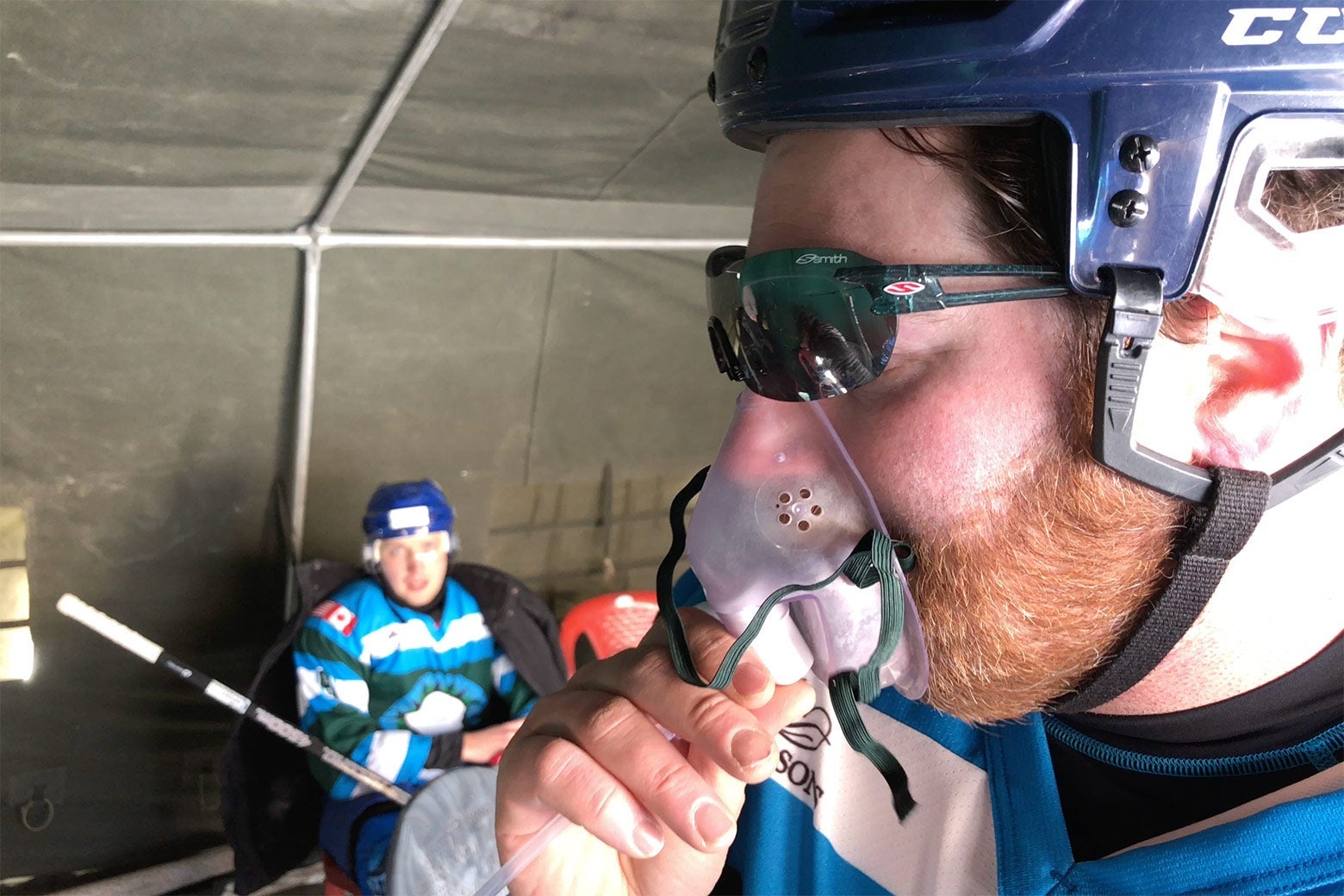 Players using oxygen tanks during a hockey game in Chibra Kargyam.