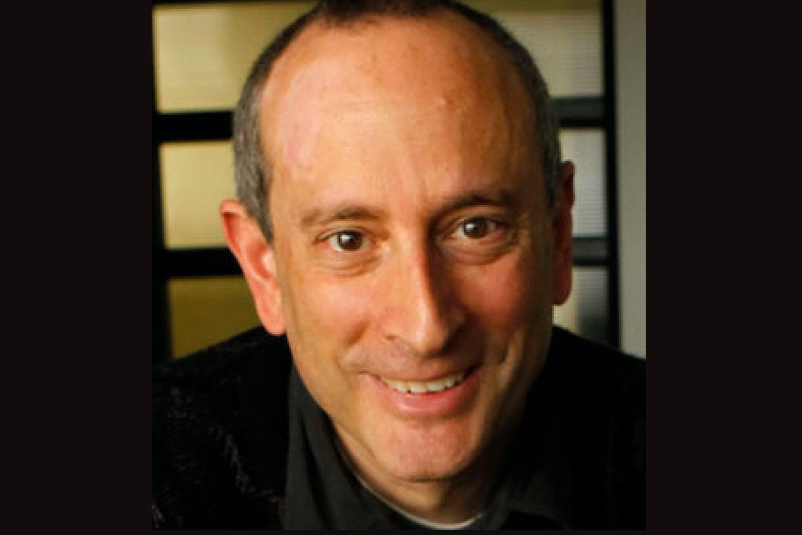 Headshot of Matthew Ginsburg smiling at the camera
