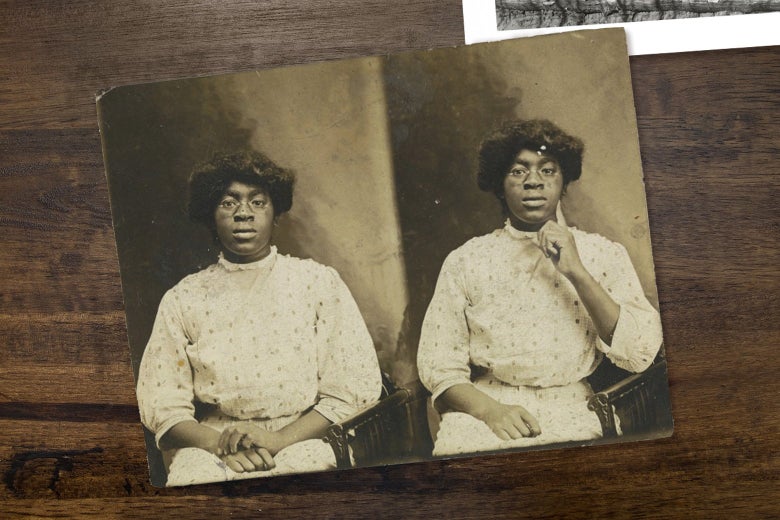A Black woman poses coyly for a portrait in a polka-dotted dress. She is seated and wearing glasses.